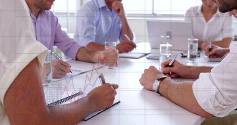 Team Taking Notes During Office Meeting for Planning, Analytics and Collaboration