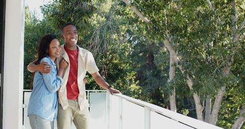 Happy Couple Enjoying Scenic Balcony View of Nature