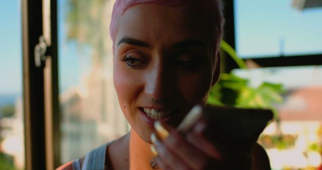 Young Woman with Pink Hair Taking a Phone Call Indoor - Download Free Stock Images Pikwizard.com