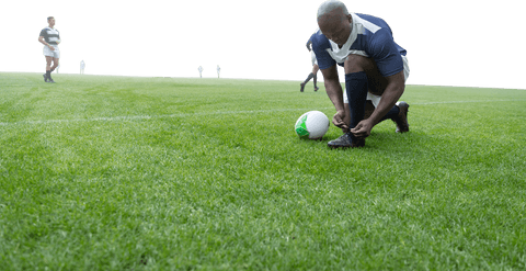 african american rugby player tying shoe on transparent background - Download Free Stock Videos Pikwizard.com