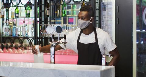Barista Wearing Mask Disinfecting Counter at Modern Bar