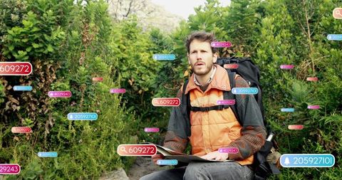 Hiker planning journey with map in lush mountain terrain