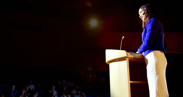 A young biracial professional woman standing at podium, addressing audience - Download Free Stock Photos Pikwizard.com