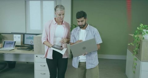 Office Colleagues Collaborating on Work Project with Laptop and Tablet