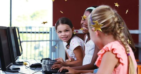 Girls learning with laptops in school computer lab
