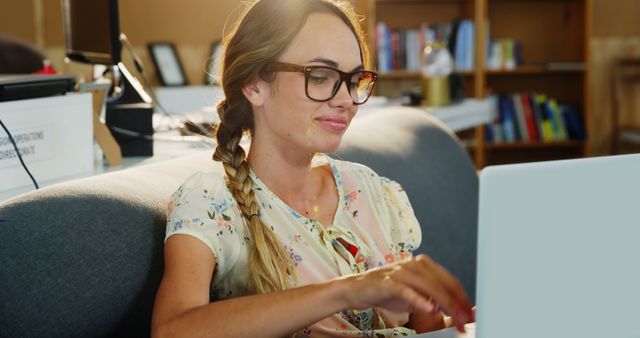 Smiling Woman with Glasses Working on Laptop in Cozy Room - Download Free Stock Images Pikwizard.com