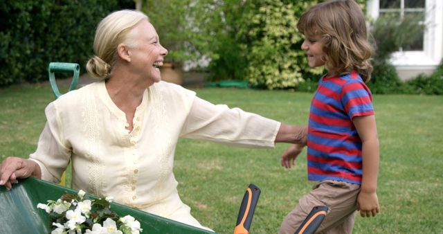 Smiling Grandmother and Child Gardening Together in Backyard - Download Free Stock Images Pikwizard.com