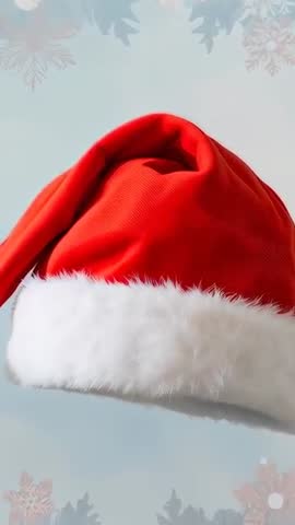 Vertical video Santa hat shifting upward revealing pom-pom on blue background with snowflakes