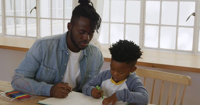 Father Teaching Young Son at Table with Coloring Supplies - Download Free Stock Images Pikwizard.com