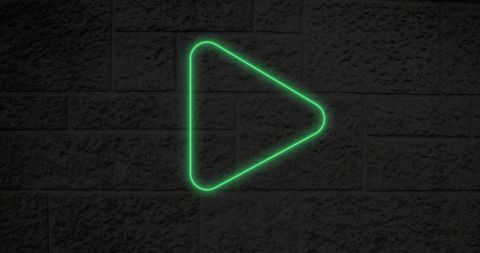 Glowing Green Neon Play Button on Textured Wall