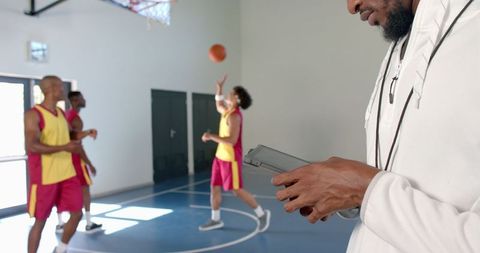 Basketball Coach Analyzing Practice on Tablet in Sports Facility - Download Free Stock Images Pikwizard.com