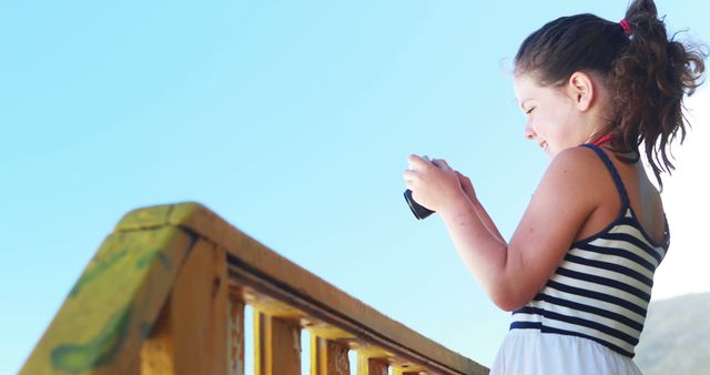 Young Girl Taking Photo on Sunny Day Outdoors - Download Free Stock Images Pikwizard.com