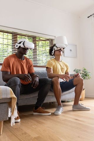 Diverse friends experiencing virtual reality gaming in casual setting