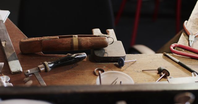 Close up of tools on wooden table in jewellery workshop. Jewellery, tools, enterpreneurship and small business.