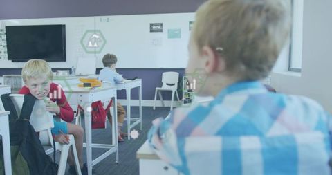 Elementary school boys engaging in classroom activities