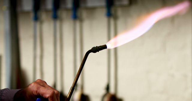 Hand Holding Torch with Flames in Workshop - Download Free Stock Images Pikwizard.com