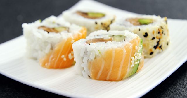 Close-Up of Delicious Assorted Sushi Rolls on White Plate - Download Free Stock Images Pikwizard.com