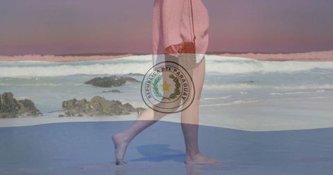 Paraguay Flag Overlay on Woman Strolling by Ocean