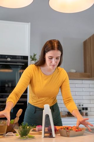 Woman Slicing Vegetables in Modern Kitchen Interior