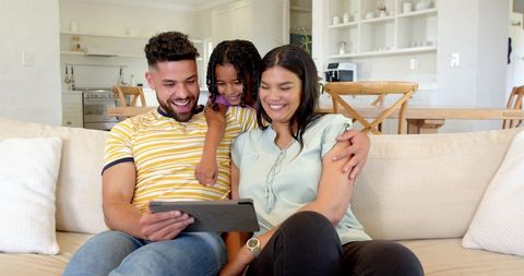 Happy Family Bonding Through Technology on Cozy Sofa