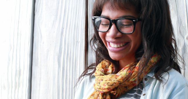 Joyful Woman Wearing Glasses and Floral Scarf Standing Outdoors - Download Free Stock Images Pikwizard.com