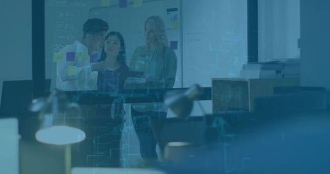 Team analyzing data in modern office with glass emergentech interface