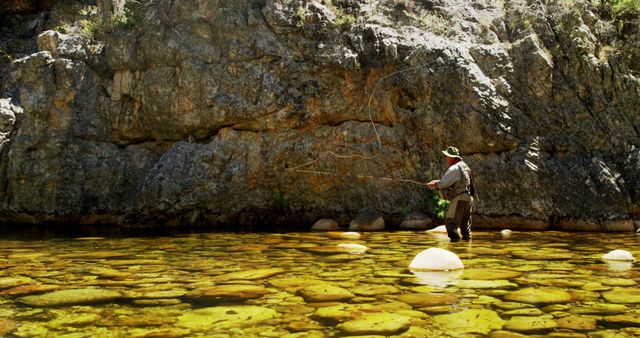 Man Fly Fishing in Rocky Stream amidst the Canyon - Download Free Stock Images Pikwizard.com