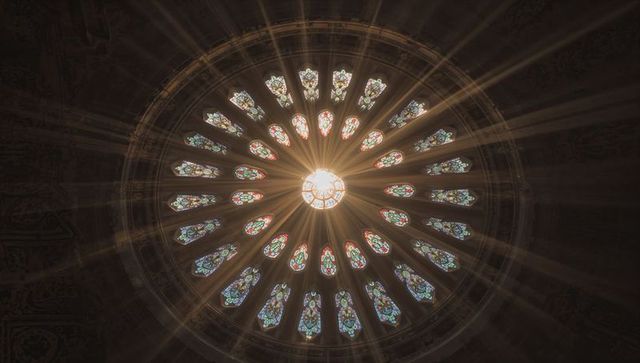Illuminated Stained Glass Rose Window Inside Gothic Cathedral