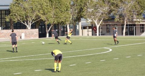 Focused referee observing intense soccer match