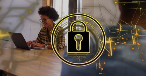 Smiling biracial woman on laptop with digital security overlay