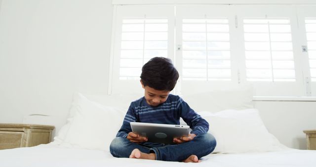Child Enjoying Digital Tablet in Bright Bedroom - Download Free Stock Images Pikwizard.com
