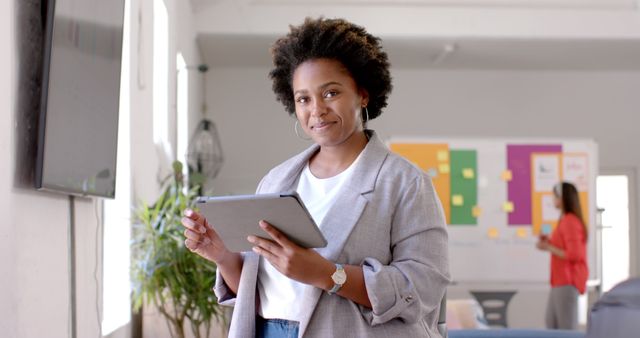 Confident Businesswoman Holding Digital Tablet in Office - Download Free Stock Images Pikwizard.com