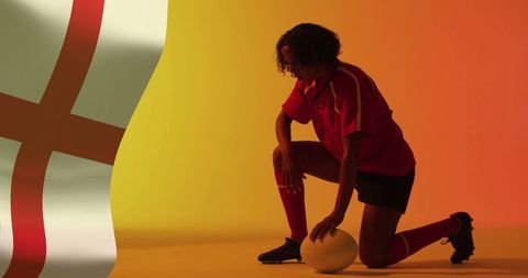 Rugby Player Kneeling with England Flag in Background