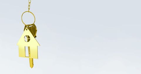 golden house key hanging from a ring on a grey background represents concepts of home ownership, real estate investment, property security, and achieving life goals. perfect for illustrating themes related to buying and selling homes, home security, unlocking potential, and symbolizing new beginnings in real estate advertisements or educational brochures.