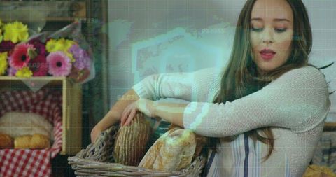 Woman arranging artisan loaves in wicker basket at rustic bakery stall with flowers