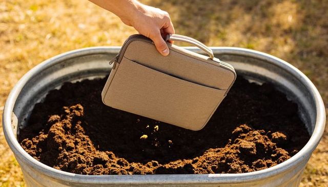 Pouring organic granules into galvanized tub for garden soil preparation and planting
