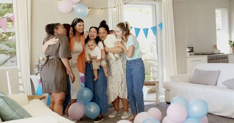 Diverse Women Celebrating Baby Shower with Balloons in Living Room