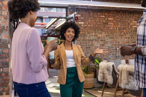 Diverse coworkers discussing ideas in modern lounge setting