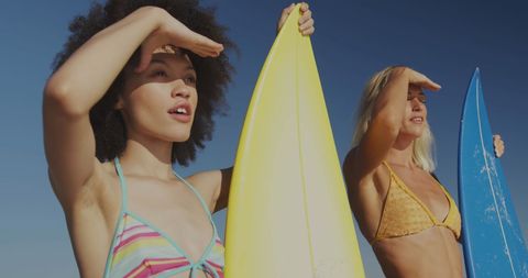 Diverse Surfers with Surfboards on Sunny Beach