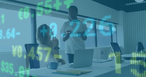 Coworkers Discussing Financial Data in Modern Office Setting