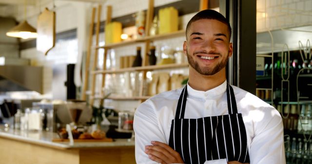 Smiling Male Barista in Coffee Shop Wearing Apron with Folded Arms - Download Free Stock Images Pikwizard.com