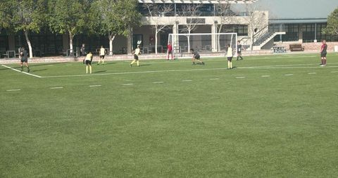 Teams Competing in a Soccer Match Near School Building - Download Free Stock Images Pikwizard.com
