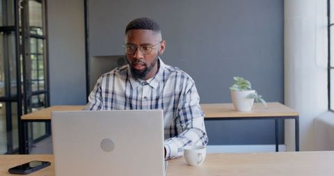 Focused Professional Conducting Online Meeting From Modern Office