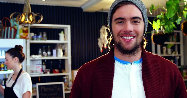 Young Male Customer in Trendy Coffee Shop Smiling at Camera - Download Free Stock Images Pikwizard.com