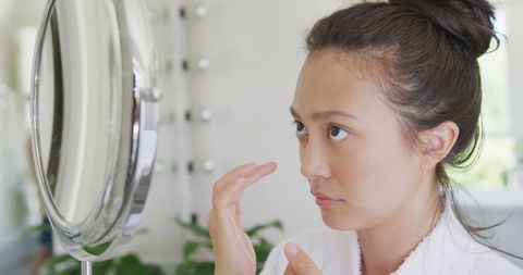 Woman Inspecting Her Skin in Mirror - Download Free Stock Images Pikwizard.com