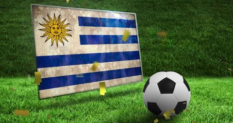 Uruguayan Flag and Soccer Ball on Grass Field Celebrating Victory