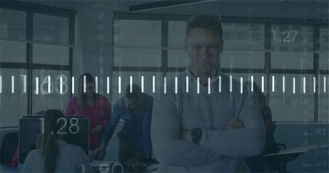 Confident business leader standing with arms crossed in modern data-driven office interior