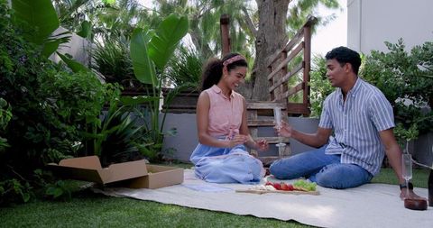 Couple Enjoys Romantic Picnic Outdoors with Wine