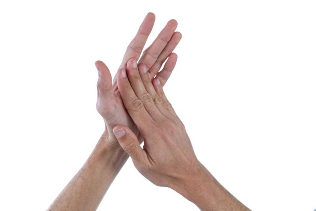 Close up of hands rubbing together against a white background. Useful for illustrating concepts related to hygiene, skin care, hand movements, and gestures. Ideal for use in health and wellness articles, instructional materials, and advertisements for hand care products.