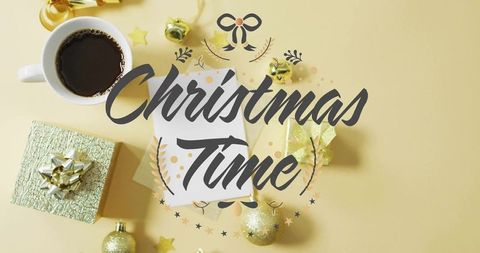 Festive golden flatlay featuring handlettered christmas time card, coffee and gifts